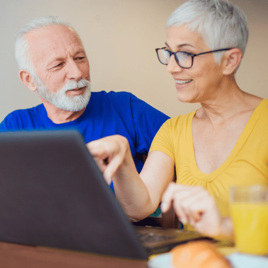 seniors couple booking a cleaning service online