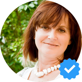 Portrait of Karen Davis, a 50-year-old woman from Burnaby, smiling with a verified checkmark, representing a satisfied Hellamaid customer.
