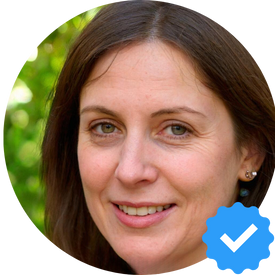 Portrait of a woman with a blue verification checkmark badge in New Westminster.