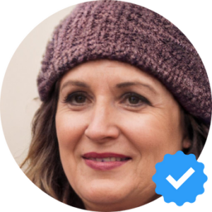 A woman in her early 40s, wearing a knit hat, smiling contentedly, representing Diane R., a happy Hellamaid customer from Kingston, Ontario.