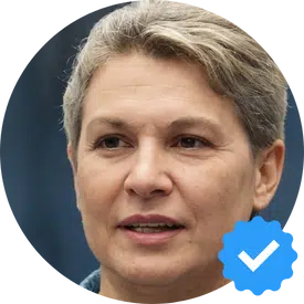 Portrait of Joan M., a satisfied female customer in her 50s, praising Hellamaid Cleaning Service for their excellent work