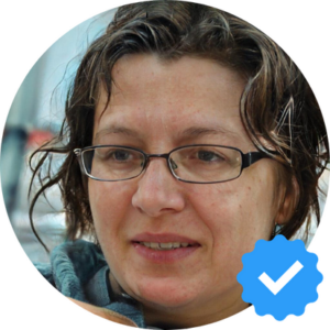 Image of Karen T., a middle-aged woman with glasses, expressing satisfaction after using Hellamaid's cleaning services in Oshawa, ON.