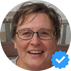 A smiling portrait of Margaret W., a 62-year-old woman from Mission, BC, happy with the cleaning service from Hellamaid