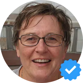 A smiling portrait of Margaret W., a 62-year-old woman from Mission, BC, happy with the cleaning service from Hellamaid