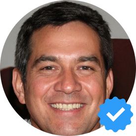 A middle-aged man, Mike S., smiling with satisfaction, representing a happy Hellamaid customer in Whitby, ON, after receiving exceptional cleaning services for his home.