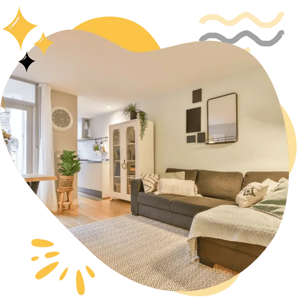 A bright and cozy living room with a comfortable sofa, stylish decor, and wooden flooring. The space is clean and inviting, showcasing the quality of Hellamaid's Airbnb cleaning services available across Canada.