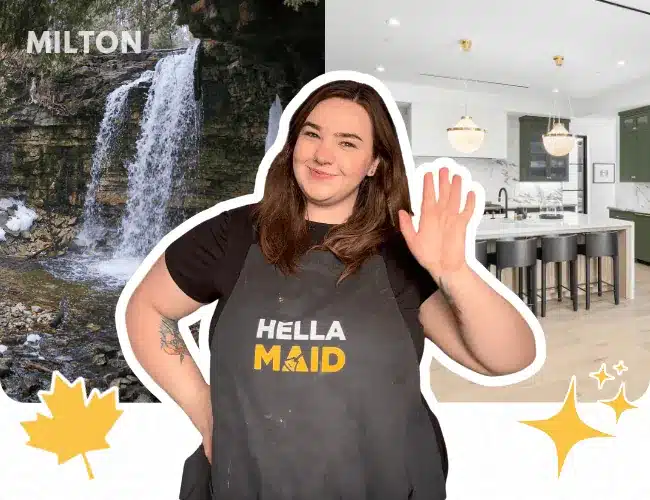Hellamaid team member in Milton with a waterfall background, wearing a Hellamaid apron and ready to provide cleaning services