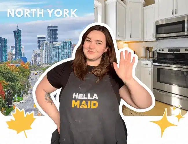 Hellamaid cleaner in North York, smiling and holding a cleaning tool with a cityscape and kitchen in the background