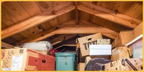 An attic filled with storage boxes and household items.