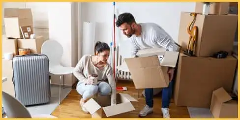 A couple arranging their move-out boxes.