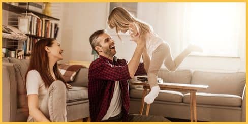 A happy family of three inside their clean home.