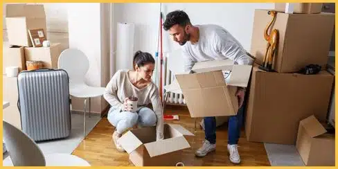 A couple with their home move-out boxes.