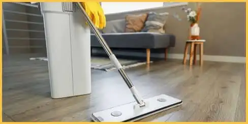 A professional cleaner's mop and bucket for cleaning a laminated floor.