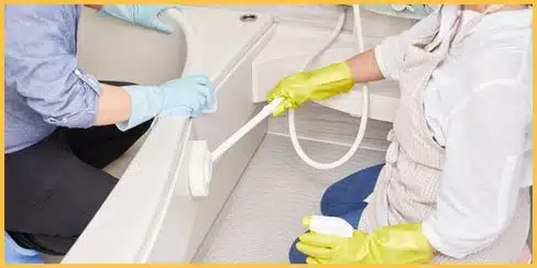 Hellamaid's professional cleaners in Calgary cleaning the bathroom.