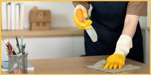 The best professional cleaner in Surrey wiping a countertop.
