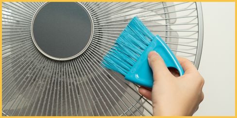 An expert cleaner brushing the fan to clean.