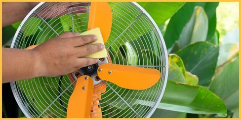 Hellamaid's professional cleaning company in Canada wiping the fan's blades.
