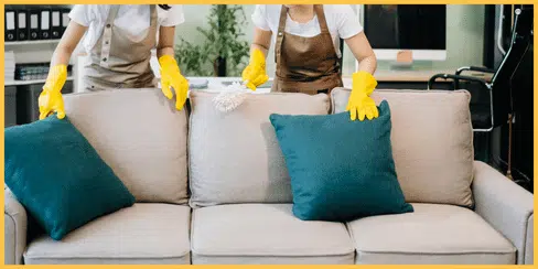 Hellamaid's cleaners that're fixing the couch pillows.