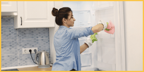 A cleaner that's cleaning a fridge.