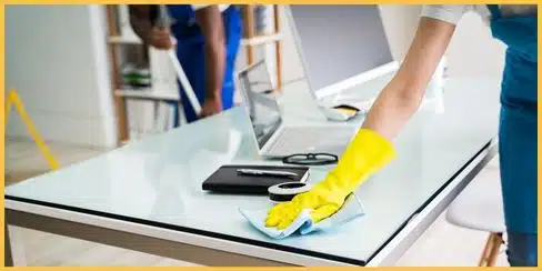 Cleaners' gloved hands wiping the book.