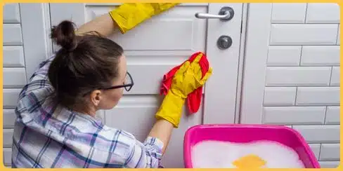 Top-rated cleaner in Canada, wiping off door stain.