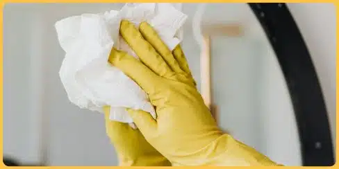 Hellamaid's cleaner wiping the mirror.