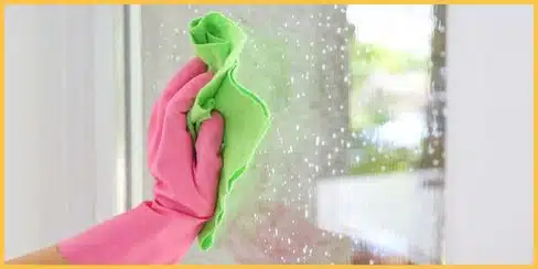 Gloved hands that's wiping the window.