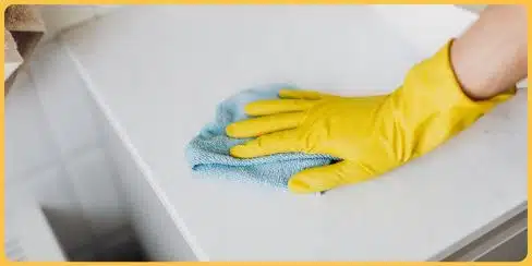 Gloved hand that's wiping a surface.